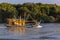 Fishing boat moves on the river against the backdrop  at sunset