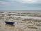 Fishing boat in the North Sea at low tide near city Wilhelmshaven, Warden Sea National Park, Germany
