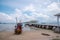 A fishing boat parked near a white wooden bridge named Atsadang Bridge on Koh Si Chang Island, Si Racha District, Thailand.