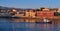 Fishing boat pass by Old Venetian harbour quay, Maritime museum of Crete in Chania, Crete, Greece. Sunrise, Cretan hills