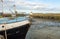 A fishing boat in the port of Saint-Vaast-la-Hougue at low tide . Normandy, France