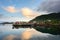 Fishing boat and red village Reflecting the water in the evening at Ballstad, Northern Norway