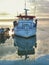 Fishing boat reflected in the icy waters of the baltic sea. Kvarsebo, Kolmarden, Sweden