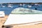 Fishing boat rest on sand beach overlooking the blue sea in Punta Umbria, Huelva, Andalusia, Spain