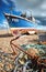 Fishing boat resting on a shingle beach. Long exposure.