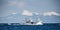 Fishing boat is returning after fishing to its port. Against the backdrop of the island of Kunashir.