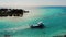 Fishing boat sails out of the bay of the island into the ocean. Maldivian fishing boat. Aerial Maldives.