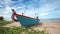 Fishing boat on sand beach and blue sky background in HD, panning tracking camera shot at day light time, low angle