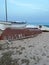 Fishing boat on sandy beach at sunset in Pineda de Mar, Spain