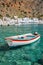 Fishing boat and the scenic village of Loutro in Crete Greece