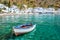 Fishing boat and the scenic village of Loutro in Crete Greece