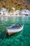 Fishing boat and the scenic village of Loutro in Crete Greece