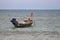 Fishing boat in the sea on background of tropical coast