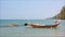 Fishing boat in the sea with mountains and blue sky