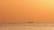 Fishing boat on sea water and during golden sunrise, 4K video