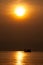 Fishing boat silhouetted with the sun