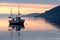 Fishing boat at sundown in the fjord