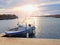 Fishing boat at sunset calm water. A motorboat for sport fishing tied to a wooden pier