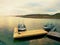 Fishing boat at sunset calm water. A motorboat for sport fishing tied to a wooden pier