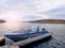 Fishing boat at sunset calm water. A motorboat for sport fishing tied to a wooden pier