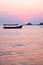 A fishing boat sunsetting casting a pink glow over Dona Paula bay, Panjim, Goa