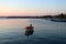 Fishing boat on Thermaikos Gulf at sunset. View of Nea Michaniona port, Thessaloniki, Greece.