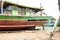 Fishing boat under repair replacing damaged wooden body parts in docks on the riverbank for