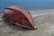 Fishing boat upside down, on the beach