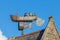 A fishing boat weather vane against a blue sky