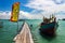 Fishing boat by a wooden bridge with a chinese flag in Tan Jetty, Clan Jetties, Georgetown, Penang, Malaysia