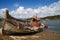 Fishing boat wrecked into a rocky river bank