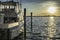 Fishing boat yacht ready to go in the ocean from a dock at sunset time