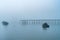 Fishing boats at anchor in harbor and mist