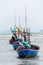 Fishing boats at bay in rainy day.