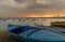 Fishing boats on the beach at dusk with Alexandria skyline in far distance and colorful sky at sunrise, Egypt