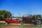 Fishing boats dock at low tide.