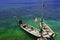 Fishing boats drift away tourists docking at the island in the blue sea.