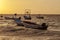 Fishing boats drift at sunrise off the coast of the Caribbean. Mexico