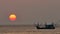 Fishing boats are floating in the Andaman Sea during sunset with golden light of the Sun before sunset and boat background in