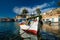 Fishing boats in harbour in fishing village of Mandrakia, Milos island, Greece