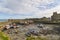 Fishing Boats lie on the silt at low tide in the inner harbour of Slade Village, overlooked by the Castle and ruins.