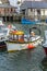 Fishing boats moored in the historic harbour at Polperro in Cornwall, UK