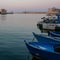 Fishing boats moored in the port in Trani, historic town in Puglia, Southern Italy. Photographed on a clear day in early autumn.