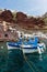 Fishing boats at Oia village harbor, below Caldera cliff at Santorini island