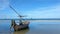 Fishing boats are parked on the beach with blue waters and blue skies on tropical landscapes.