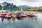 Fishing boats at the pier with mountain in the background at Husoy village, Senja island, Norway