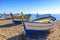 Fishing boats rest on a golden sand beach