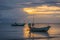 Fishing boats in the sea and beautiful sky while the sunset.