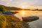 Fishing boats on the shore of a large river, lake. Early morning, fog, haze.