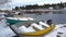 Fishing boats, snow and lead-gray water of the Baltic Sea. Dolly shot.